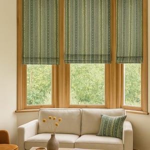 Custom Roman blinds and accent cushion in sage green stripe fabric with ethnic-inspired motifs – handmade window coverings for cozy, earthy interiors