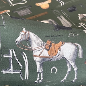 May include: A white horse with a brown saddle and bridle on a green background. The text "Cheval de Sous-Officier N&deg;1857 PARIS" is printed on the fabric.
