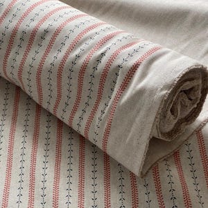 Traditional ticking stripes are softened by miniature floral sprigs for a modern farmhouse vibe.
