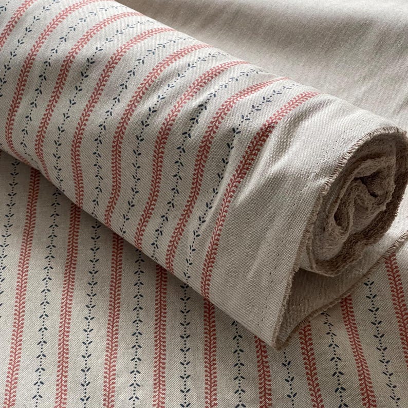 Traditional ticking stripes are softened by miniature floral sprigs for a modern farmhouse vibe.