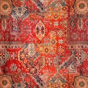 May include: A red, orange and blue patterned rug with a geometric design. The rug is made up of several different squares and rectangles, each with its own unique pattern.