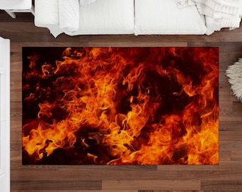 May include: A rug with a fiery orange and yellow flame pattern on a black background.