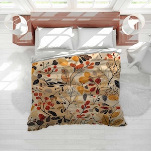 May include: A beige duvet cover with a botanical pattern featuring leaves and berries in shades of orange, red, yellow, and black. The bedding is on a wooden bed frame with white pillows and a white sheet. The room has white walls and windows.