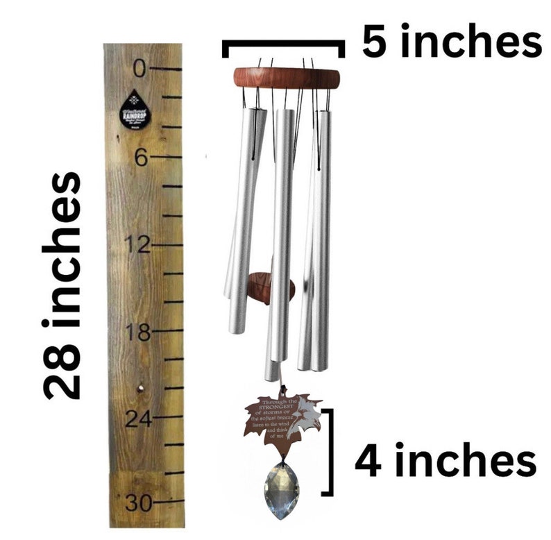 May include: Silver wind chime with a wooden top and a crystal prism at the bottom. The chime is 28 inches long and has a leaf-shaped charm with the text "Through the strongest storms the truest hearts will always find their way home".