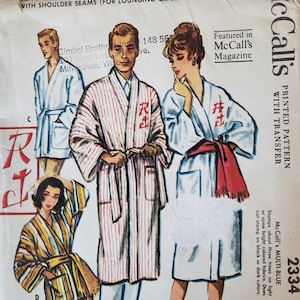 May include: A vintage McCall's sewing pattern envelope, number 2334, for robes in two lengths. The cover features illustrations of four individuals wearing various robe styles, including striped and solid designs, with text detailing size large.