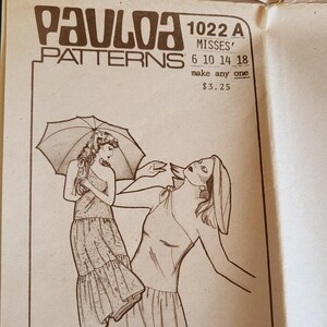 May include: Vintage Paula Patterns sewing pattern for Misses' dresses. The pattern features illustrations of two dress designs, labeled View A and View B. The pattern includes sizing information and the address 1211 Kona St. Honolulu, HI. 96814.
