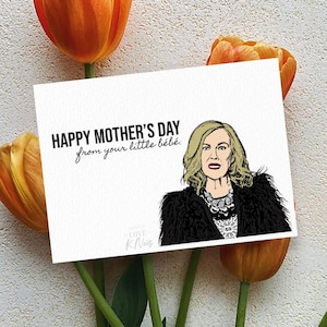 May include: A Mother's Day card with a cartoon illustration of a woman, surrounded by orange tulips. The card reads "HAPPY MOTHER'S DAY from your little b&eacute;b&eacute;."