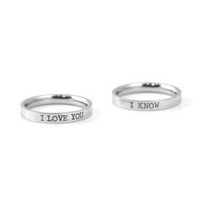May include: Two silver rings with the words "I love you" and "I know" engraved on them.
