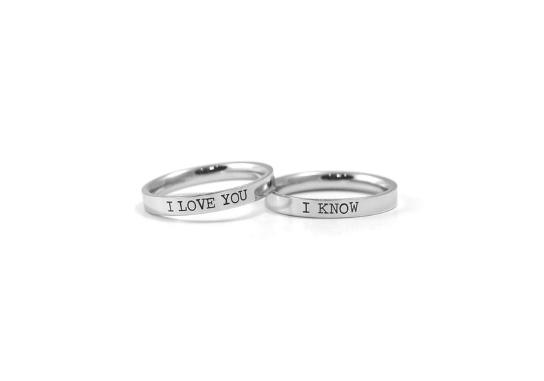 May include: Two silver rings with the words "I love you" and "I know" engraved on them.