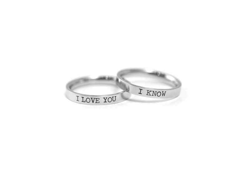 May include: Two silver rings with the words "I love you" and "I know" engraved on them.