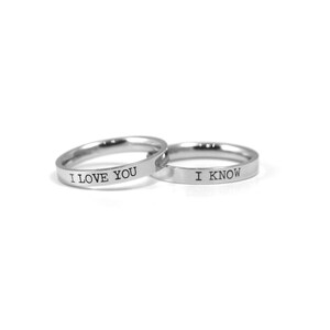 May include: Two silver rings with the words "I love you" and "I know" engraved on them.