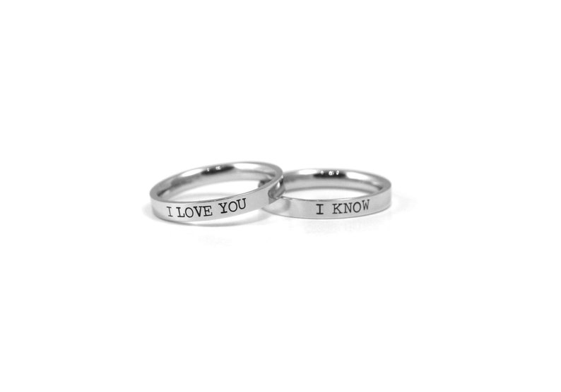 May include: Two silver rings with the words "I love you" and "I know" engraved on them.