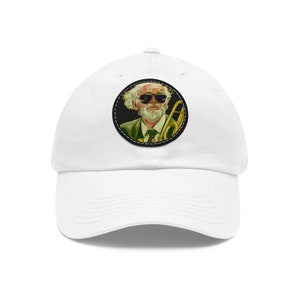 May include: White baseball cap with a round patch featuring a cartoon of a man with a white beard and sunglasses playing a trombone.