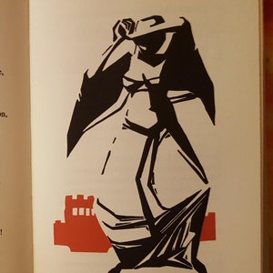 May include: A black and white illustration of a person in a long robe, with a castle in the background. The text "Macbeth" is printed in black at the top of the page. The text "She should have died hereafter;" is printed in black at the bottom of the page.