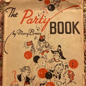 May include: Vintage book cover titled "The Party Book" by Mary Breen. The cover features illustrations of people in party hats and balloons in red, black, and white. The book has a worn, aged appearance.