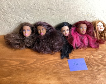 Barbie, Skipper, Stacie, and Monster High doll heads and wigs in black, brunette, blonde, green, purple, and other hues in assorted styles