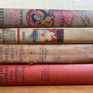 4 antique boys adventure books with military themes focus on traditional martial virtues of courage, comradeship, and patriotism.