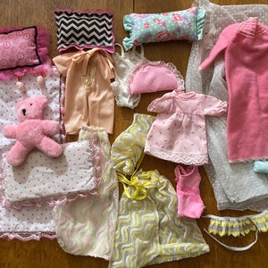 Vintage Barbie lingerie, pajamas, and bedding, including 1982 Dream House canopy and drapes and 1978 Pretty Changes yellow-and-white set