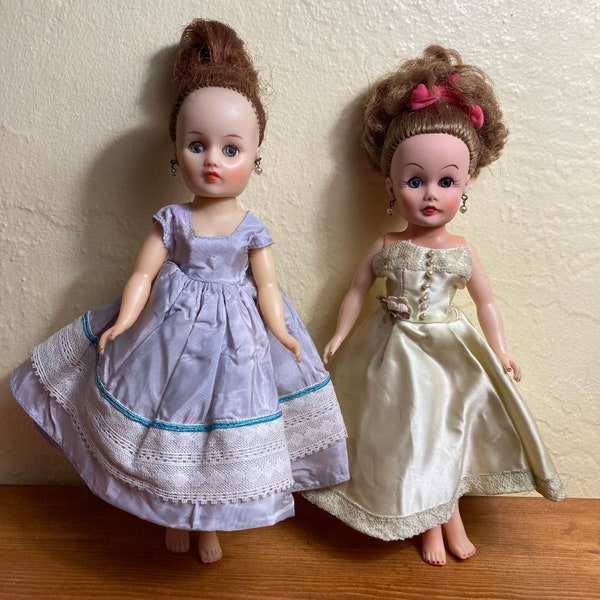 Two 1960s 10-inch Horsman Sindy dolls with pearl dangly earrings, sleepy eyes, with upswept auburn hair and twist-and-turn bodies