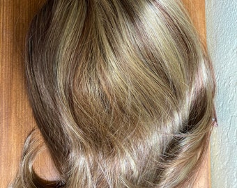 Long doll wigs for either medium dolls or people wanting to add a bounce to their coifs: a very curly blonde pigtail and swishy brunette