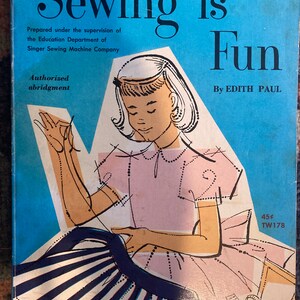 May include: A book cover with a blue background and the title "Sewing is Fun" in black text. The book is an authorized abridgment prepared under the supervision of the Education Department of Singer Sewing Machine Company. The cover features a young girl in a pink dress sewing a striped skirt. The book is priced at 45 cents and has the code TW178.
