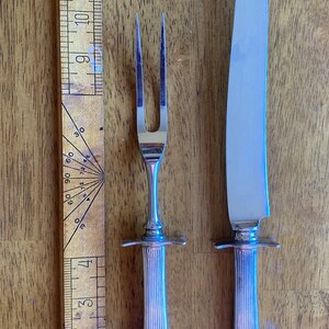 Vintage Oneida Community replacement carving fork and knife set with an Art Deco design of interlaced diamond patterns and classical motifs