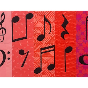 May include: A colorful fabric art piece with musical notes and a treble clef. The background is a patchwork of red, pink, and white fabric.