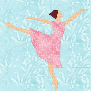 May include: A pink paper ballerina with a white floral pattern on her dress, standing on one leg with her other leg extended in the air. The ballerina is against a light blue background with a white floral pattern.