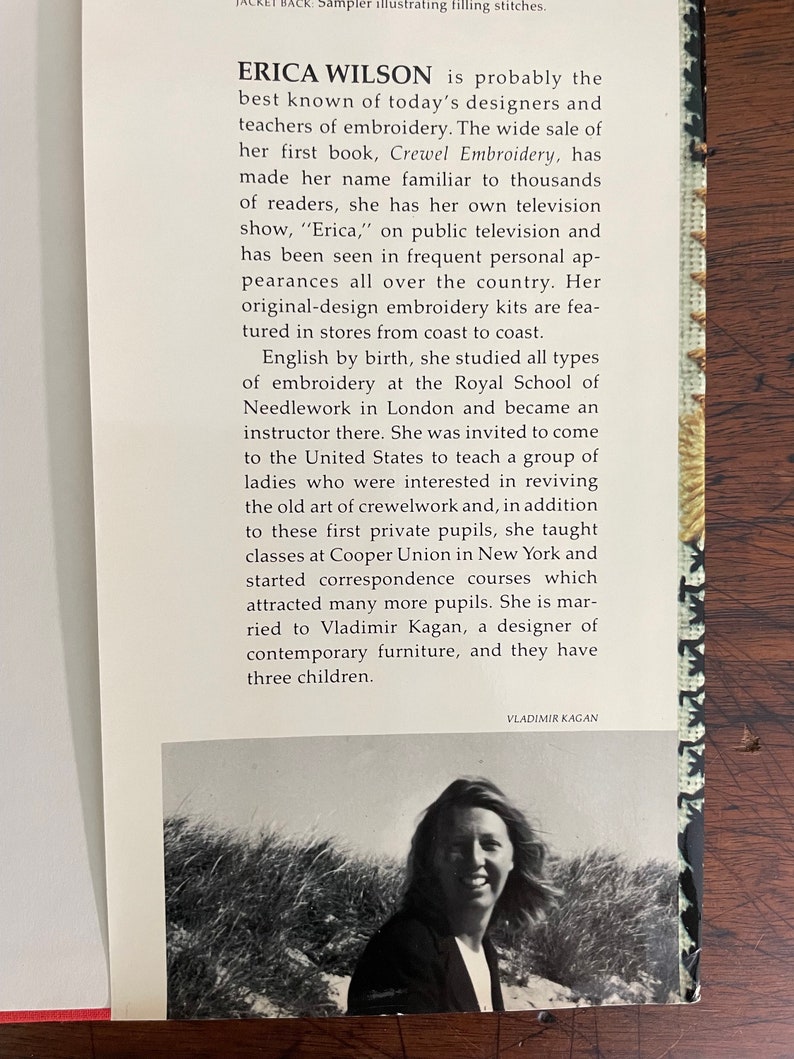 May include: A book cover featuring text about Erica Wilson, a designer and teacher of embroidery. The cover includes a black and white photo of a woman and text about her work and television show.