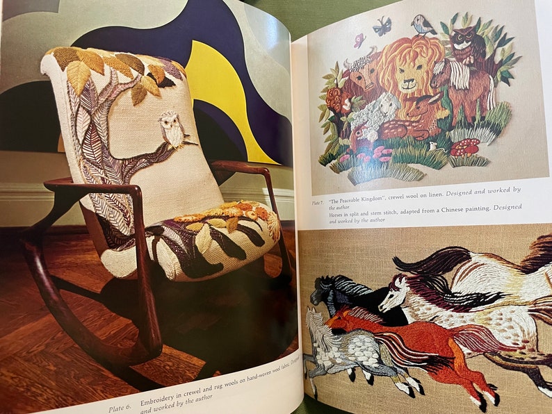 May include: A vintage rocking chair with a cream-colored upholstered seat and back, featuring an embroidered tree design with an owl. The chair has dark wooden arms and a wooden frame. The image is from a book about embroidery.