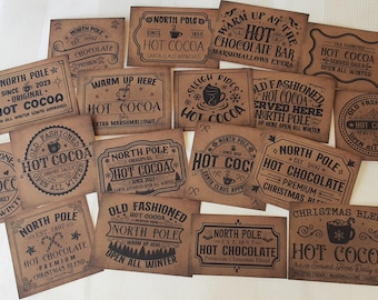May include: A collection of vintage-style brown paper signs with black text, advertising "Hot Cocoa" and "Hot Chocolate." The signs feature various designs, including snowflakes, mugs, and the words "North Pole."