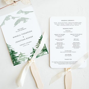 May include: Two wedding fan programs with a mountain and forest design. One fan has the text "Welcome to our wedding" and the names Mikaela Thompson & Jonathan Bishop. The other fan lists the wedding ceremony details.