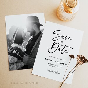 May include: Save the Date card with a black and white photo of a couple in love. The text reads "Save the Date" in a script font, followed by "For the Wedding of Amelia + Nicolas" and "August 18th, 2045 Vancouver, BC". The card also includes the text "Invitation to follow".