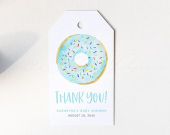 May include: Blue and white donut with colorful sprinkles on a white thank you tag. The tag says "Thank You!"  "Kathryne's Baby Shower" and "August 18, 2045".