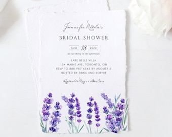 May include: A white invitation card with lavender flowers printed on the bottom. The text reads "Join us for Natalie's Bridal Shower, Aug 18, 2023, at two-thirty in the afternoon, Lake Belle Villa, 154 Maine Ave, Toronto, ON, RSVP to 888 987 6543 by August 5, Hosted by Erika and Sophie, Registered at Macy's - Pottery Barn."