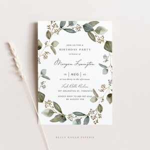 May include: A white invitation card with a watercolor eucalyptus wreath design. The card includes text announcing a birthday party, the name "Morgan Lexington", date, time, and location details. The card is decorated with green and brown leaves.