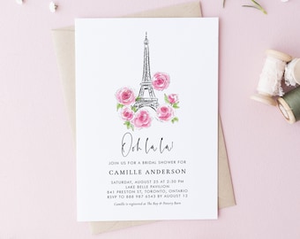 May include: A white bridal shower invitation with a black and white illustration of the Eiffel Tower with pink roses. The text reads "Ooh la la! Join us for a bridal shower for Camille Anderson Saturday, August 25 at 2:30 PM Lake Belle Pavilion 841 Preston St, Toronto, Ontario RSVP to 888 987 6543 by August 13 Camille is registered at The Bay & Pottery Barn"