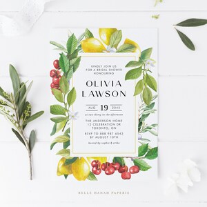 May include: A white bridal shower invitation with a gold border. The invitation features a watercolor illustration of lemons, cherries, and greenery. The text reads "Kindly join us for a bridal shower honouring Olivia Lawson, Aug 19, 2045 at two-thirty in the afternoon, The Anderson Home, 12 Celebration Dr, Toronto, ON, RSVP to 888 987 6543 by August 10th, hosted by Sophie & Erika, Belle Hanah Paperie."