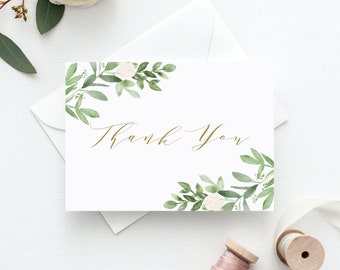 May include: White thank you card with a gold "Thank You" inscription and a watercolor design of white flowers and green leaves.