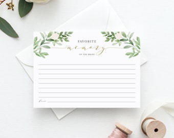 May include: A white card with a green floral border and gold lettering that says "Favorite Memory of the Bride". The card has lined space for writing.