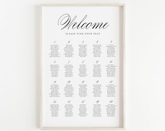 May include: A white framed seating chart with black text. The chart is titled "Welcome, Please Find Your Seat." The chart lists guest names by table number.