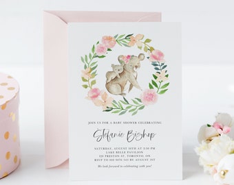 May include: A baby shower invitation with a watercolor illustration of two koalas in a floral wreath. The invitation is for Stefanie Bishop and includes the date, time, and location of the event. RSVP information is also included.
