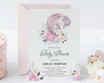 May include: A pink and white baby shower invitation with a watercolor illustration of a unicorn with a floral wreath. The text reads "Join us for a Baby Shower Celebrating Aurelia Thompson Saturday, July 18 at 2 PM Fleur Tea House 8120 Meadows St, New York Hosted by Alexandra RSVP to 888 987 6543 by July 10"