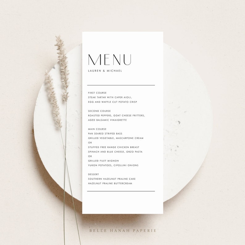 May include: A minimalist wedding menu card with a black and white design. The menu features a three-course meal with options for each course. The card is printed on a cream-colored paper stock and has a simple, elegant design.