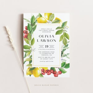 May include: A white bridal shower invitation with a watercolor illustration of lemons, cherries, and greenery. The text reads "Kindly join us for a bridal shower honouring Olivia Lawson, Aug 19, 2045 at two-thirty in the afternoon, The Anderson Home, 12 Celebration Dr, Toronto, ON, RSVP to 888 987 6543 by August 10th, hosted by Sophie & Erika, Belle Hanah Paperie."