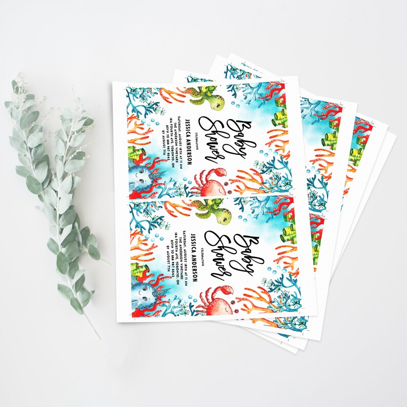 May include: A stack of baby shower invitations with a blue and green watercolor background featuring a crab, a turtle, and coral. The text on the invitation reads "Baby Shower" and includes the date, time, and location of the event.