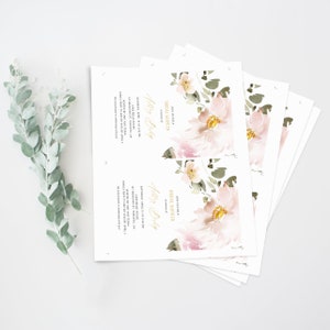 May include: A stack of white bridal shower invitations with a watercolor floral design in shades of pink and green. The text on the invitation reads "Join us for a Bridal Shower" and "Ashley Bishop".