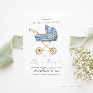May include: A blue and gold baby carriage with white flowers and a blue ribbon. The invitation reads "Join us for a Baby Shower in honour of Stefanie Thompson. Saturday, August 18th at 2:30 PM, Lake Belle Pavilion, 145 Rosemary St, New York. Hosted by Margo and Sophie. Kindly RSVP to 888 987 6543 by August 7th. Belle Hanah Paperie."