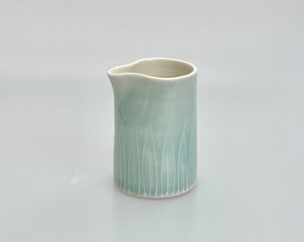 Small handleless light blue porcelain jug