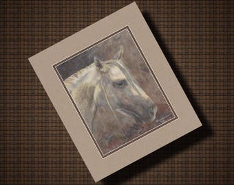 May include: A framed print featuring a detailed watercolor painting of a horse's head. The horse has a light-colored coat and a dark muzzle, set against a muted background. The print is matted in a neutral tone and framed.